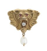 A lion mask brooch with with ruby, diamond and pearl drop