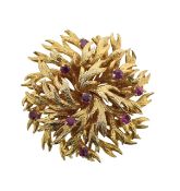 A 1970's textured flower brooch set with rubies
