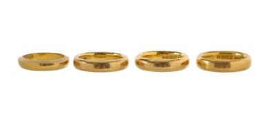 A group of four 22ct gold wedding bands