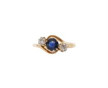 An Edwardian three stone sapphire and diamond ring
