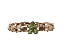 An Edwardian diamond and peridot flower on expanding bracelet