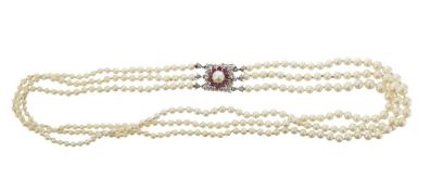 A three row graduated pearl necklace with ruby clasp