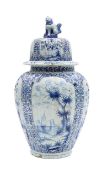 A Delft style blue and white pottery vase and cover
