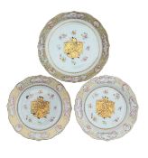 A pair of famille rose European over-decorated plates and a dish