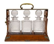 A Betjemann's Patent oak three bottle tantalus