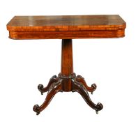 A rosewood fold over card table