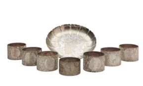 A George V silver strawberry dish and seven Elizabeth II silver napkin rings