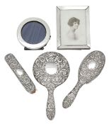 An Edward VII silver dressing table set and two silver photograph frames