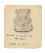 An Egyptian white faience amulet of Bes
