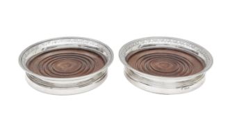 A pair of silver wine coasters
