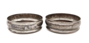 A pair of silver wine coasters