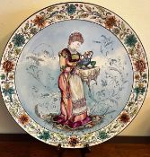 LATE 19th, EARLY 20th CENTURY POLYCHROME CERAMIC PLAQUE, WELL DRAWN FIGURE AND FLORAL BORDER,