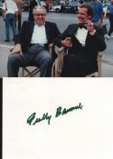 Cubby Brocolli signed 6x4inch white card with accompanying colour photo pictured with Roger Moore.