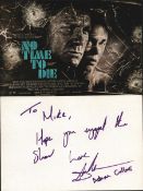 Adam Collins signed white card with accompanying No Time to Die photo.