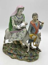 A Staffordshire figure group of Joseph and Mary's flight into Egypt 27cms In restored condition