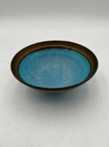 A Lucie Rie style studio pottery bowl, the turquoise ground body with a bronzed rim 6 x 16cm