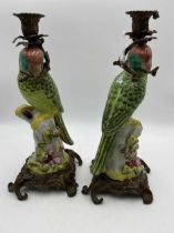 Pair of ormolu mounted ceramic candle holders in the form of a pair of green parrots 36cm High