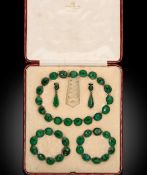 A 19th century cased green paste demi parure,