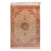 An extremely fine and signed silk Qum carpet, central Persia