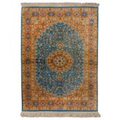 An extremely fine, signed silk Qum rug, central Persia