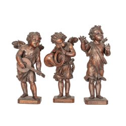 A set of three Italian carved walnut musical putti 19th century