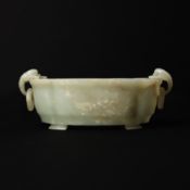 A Chinese celadon jade 'floral' marriage bowl, Qing dynasty, 19th century 清十九世紀 青玉花卉紋活環洗