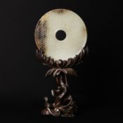 A fine Chinese celadon and russet jade disc, bi, Western Han dynasty 西漢 青玉帶皮璧