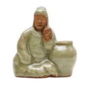 A Chinese Longquan celadon-glazed biscuit figure, Ming dynasty 明 龍泉青釉露胎人物坐像