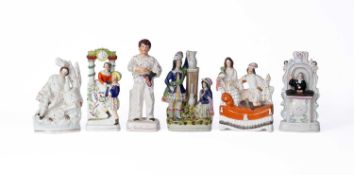A collection of Staffordshire pottery figures and groups