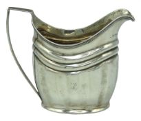An 1802 George III London silver cream jug, rubbed