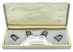 A boxed set of 1985 silver thimbles featuring four