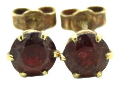 A pair of 9ct gold earrings set with garnet, 6mm d