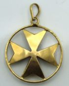 A yellow metal pendant depicting Maltese cross, te