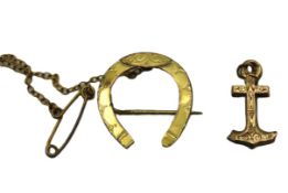A 9ct gold horseshoe brooch & part of an anchor, b