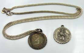 A silver chain with two St. Christopher medallions