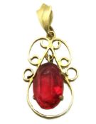 A 9ct gold pendant set with red stone, 27mm drop,