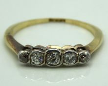 An 18ct gold ring set with five small diamonds of