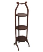 An Edwardian three tier mahogany folding cake stan