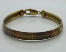 A three colour gold plated sterling silver bracele