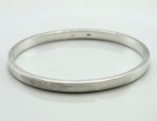 A contemporary solid silver bangle, 65mm x 55mm, 3