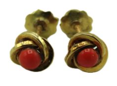 A pair of yellow metal coral earrings with screw s