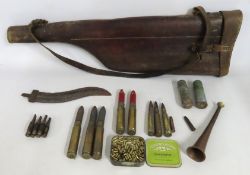 A copper hunting horn, 230mm long, a leather gun c