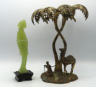 An Arabian brass ornamental centrepiece featuring palm tree over camel & Arabian man, 275mm tall twi