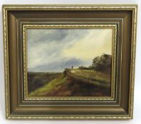 A framed oil of landscape with lone figure, signed