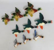 Three sets of graduated flying duck wall plaques,