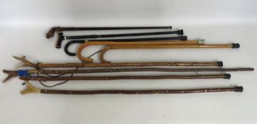 A collection of five various walking canes, one wi