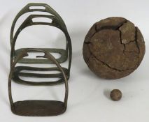 Three antique stirrup irons twinned with a cannonb