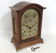 A German oak bracket style chiming clock with bras