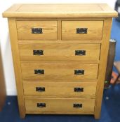 A modern chest of oak drawers, 1203mm tall x 950mm