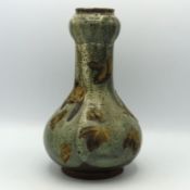 A Japanese folk art pottery vase with applied leaf